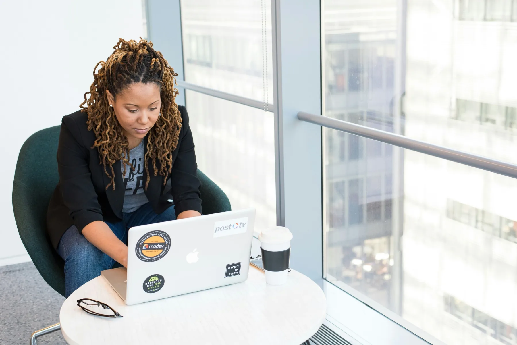 Professional woman working independently on a laptop